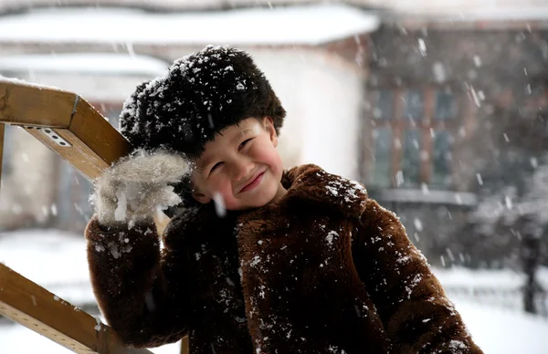 Boy under snowfall — Stock Photo, Image