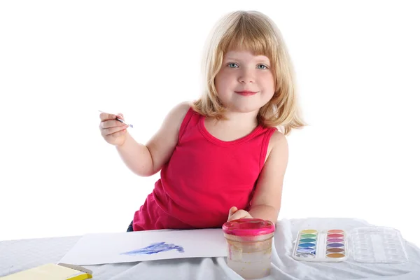 Menina com tinta ao lado da mesa — Fotografia de Stock