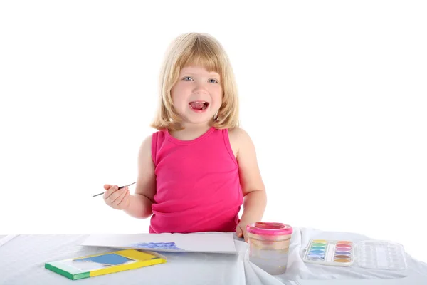 Chica con pintura al lado de la mesa —  Fotos de Stock