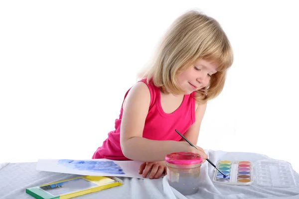 Girl with paint beside table — Stock Photo, Image