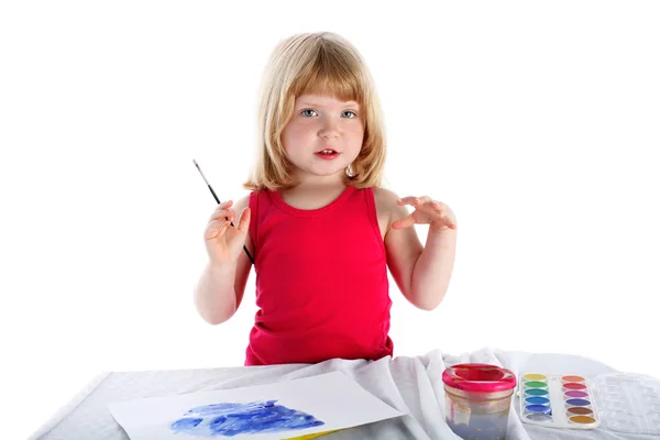 Dziewczyna z farby obok tabeli — Zdjęcie stockowe