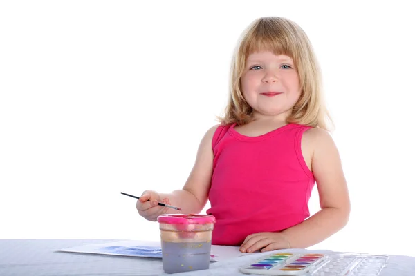 Девушка с краской возле стола — стоковое фото