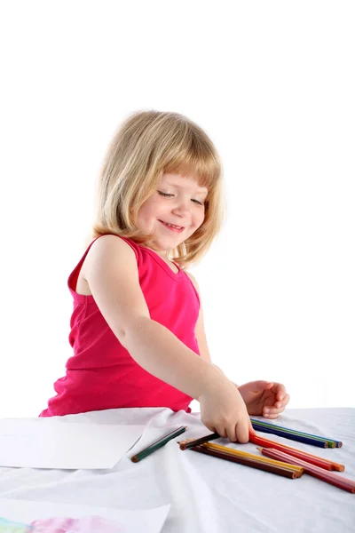 Girl with pencil beside table — Stock Photo, Image