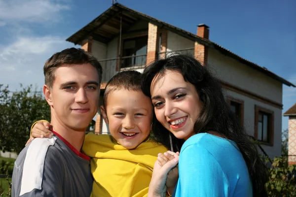 stock image Family beside their new house