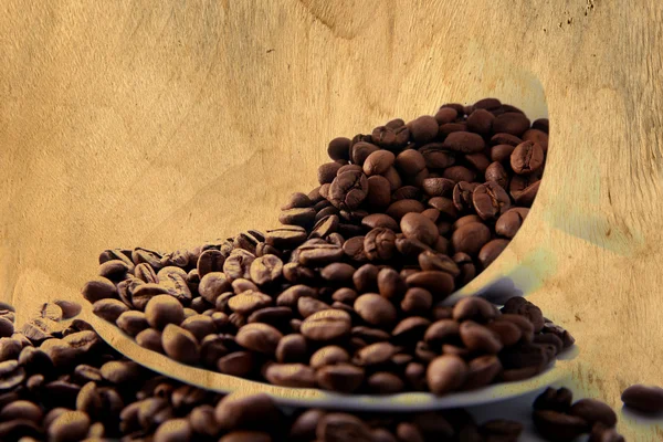 stock image Beans of coffee paint at wood plate