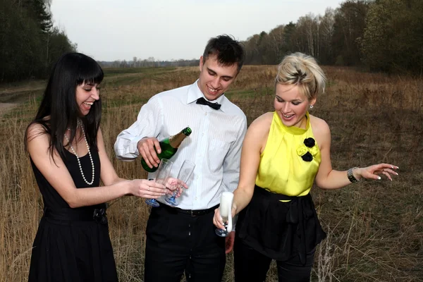 Two girl and man with wine — Stock Photo, Image