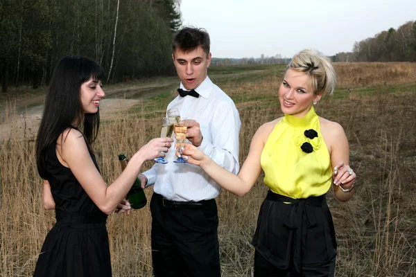 Two girl and man with wine — Stock Photo, Image