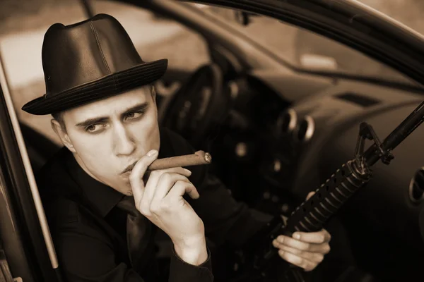 Człowiek w samochodzie z cygarem i karabin — Zdjęcie stockowe