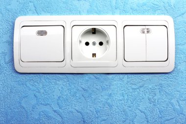 Electrical switch and plug in blue wall clipart