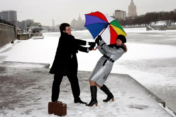 Chica y hombre luchando con paraguas — Foto de Stock