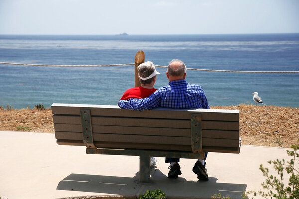 Elderly couple at sea with seagull