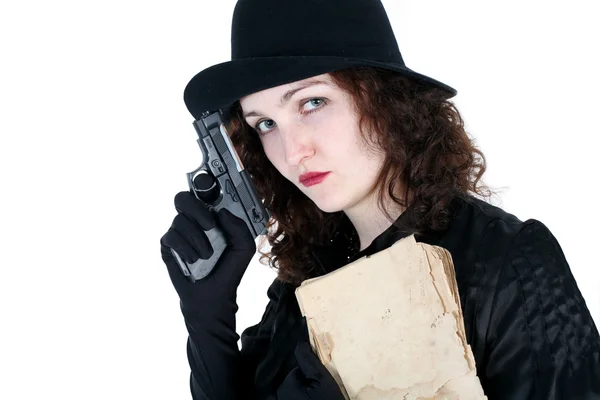 Girl in hat with old book and gun — Stock Photo, Image