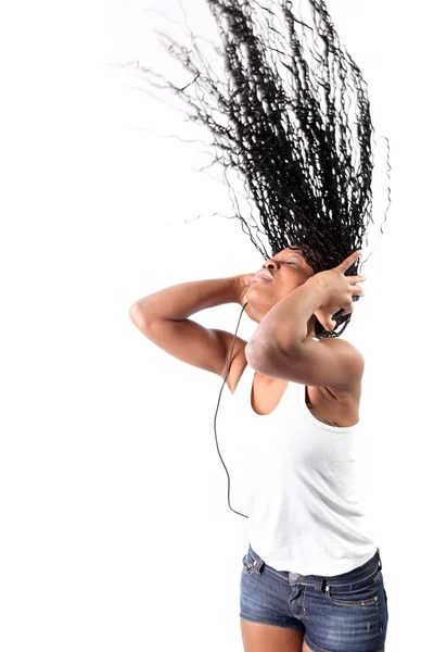 Afro-american with long hairs listen music in headphones isolate — Stock fotografie