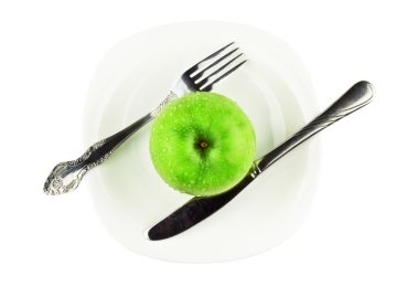 Fork, knife, green apple on white dish clipart