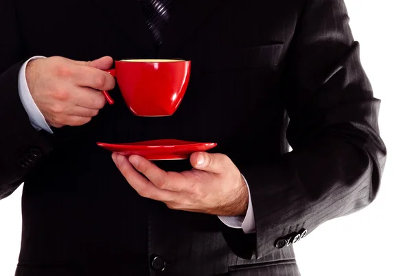 Чоловік у чорному костюмі тримає чашку кави — стокове фото