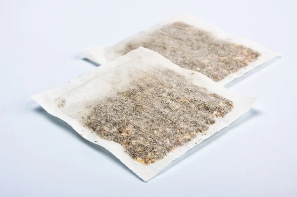 Herbal tea bags laying on table — Stock Photo, Image