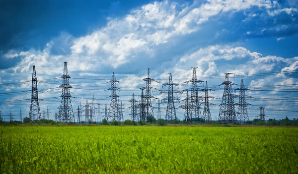 Summer meadow with high-voltage towers