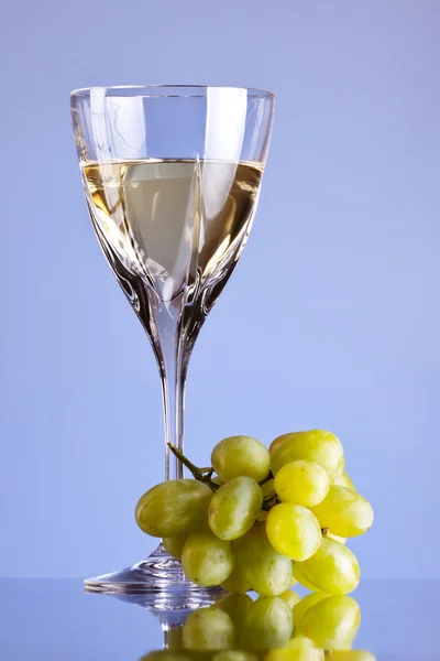 stock image Glass of white wine and grape