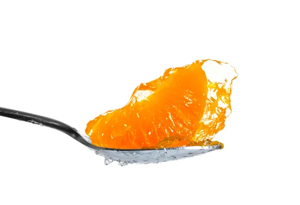 Mandarin in jelly on spoon — Stok fotoğraf