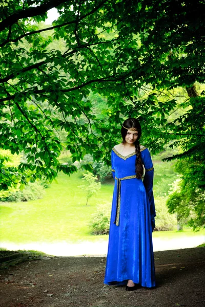 Beautiful princess in shadow of big trees — Stock Photo, Image