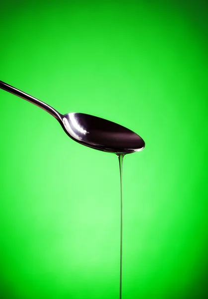 Oil spill out of spoon — Stock Photo, Image