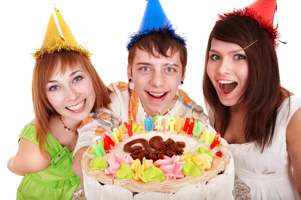 Gruppe im Partyhut mit Geburtstagstorte. Stockbild