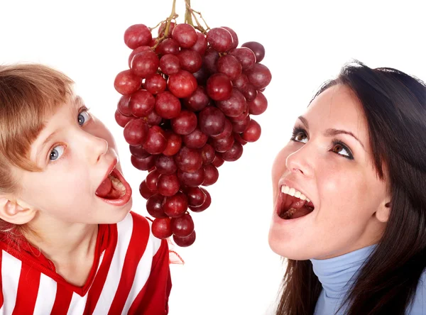 Boldog család anya és lánya eat szőlő. — Stock Fotó