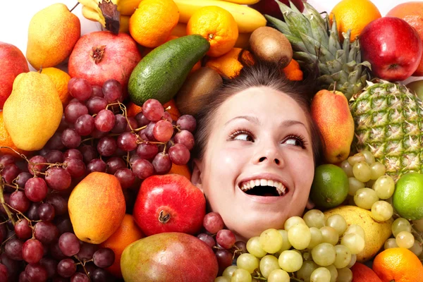 Girl in group of fruit. — Stock Photo, Image