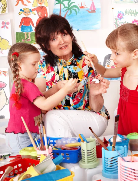 Children painting with teacher in preschool. — Stock Photo, Image