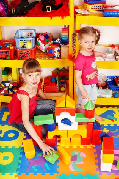 Child with puzzle, block and construction set in play room. — Stock Photo, Image