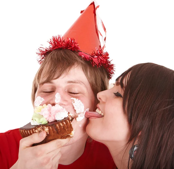 Man in party hat and girl eating cake. — Stock Photo, Image