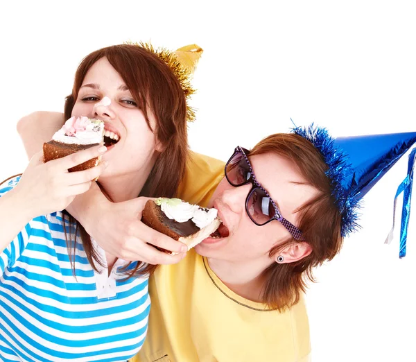 Man in party hat and girl eating cake. — Stock Photo, Image
