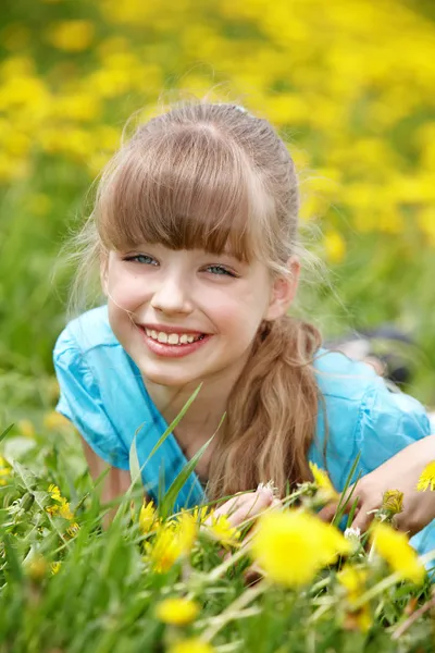 Dziecko, leżąc na trawie w kwiat. — Zdjęcie stockowe