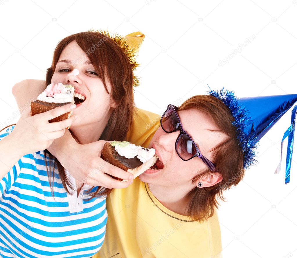 Man in party hat and girl eating cake.