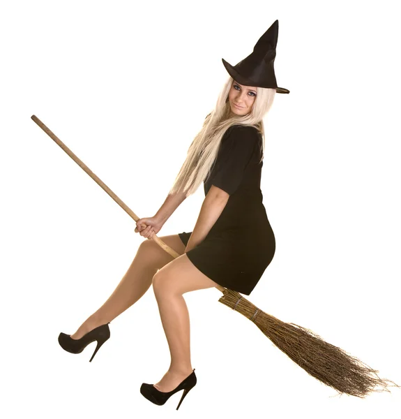 Halloween witch in black dress and hat on broom. — Stock Photo, Image