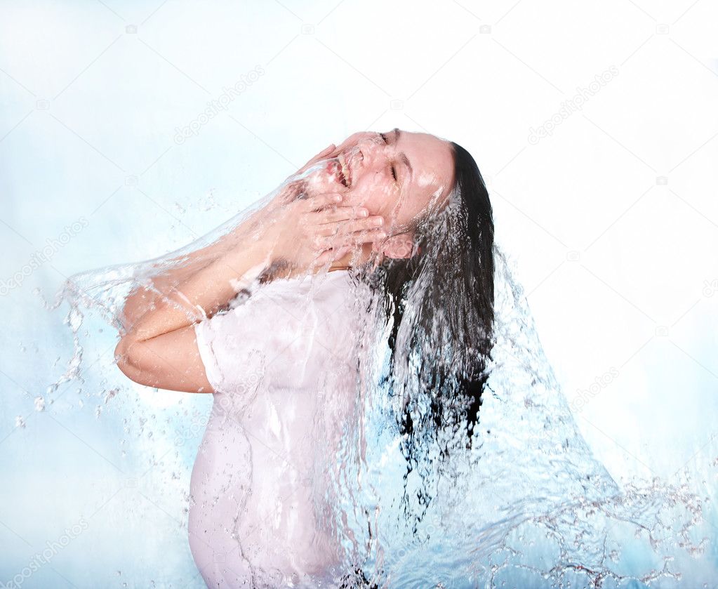 Girl in water splashing. Body care.