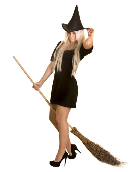 Halloween witch in black dress and hat on broom. — Stock Photo, Image