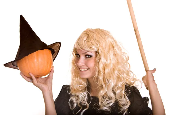 Halloween witch in black hat with pumpkin on broom. — Stock Photo, Image