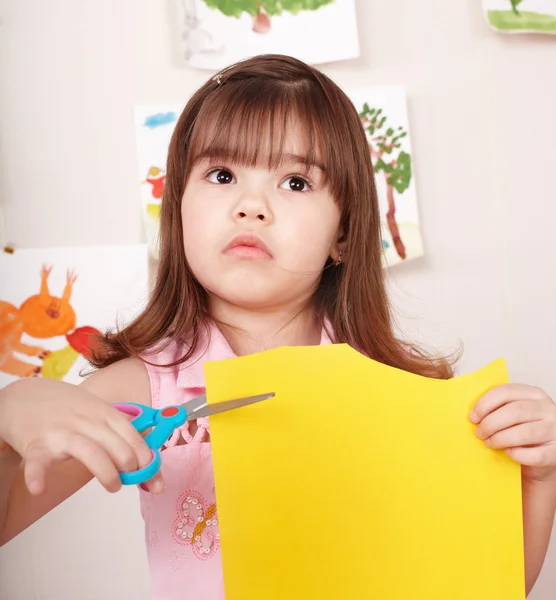 Serious child cutting paper. — Stock Photo, Image