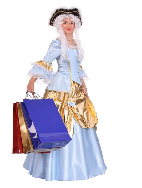 Kobieta w okresie sukienka z torby na zakupy. — Zdjęcie stockowe