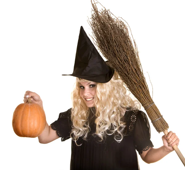 Halloween witch blond in black hat and dress with pumpkin on broom. — Stock Photo, Image