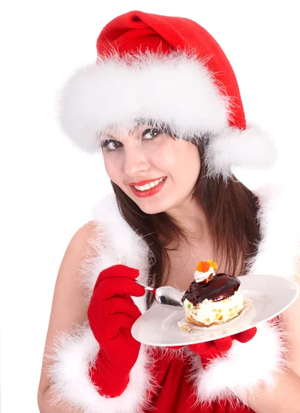 Noel kız kırmızı santa şapka ve pasta plaka üzerinde. — Stok fotoğraf