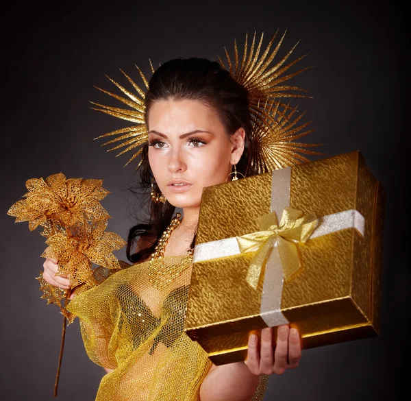 Young woman with gold feather on grey background. — Stock Photo, Image