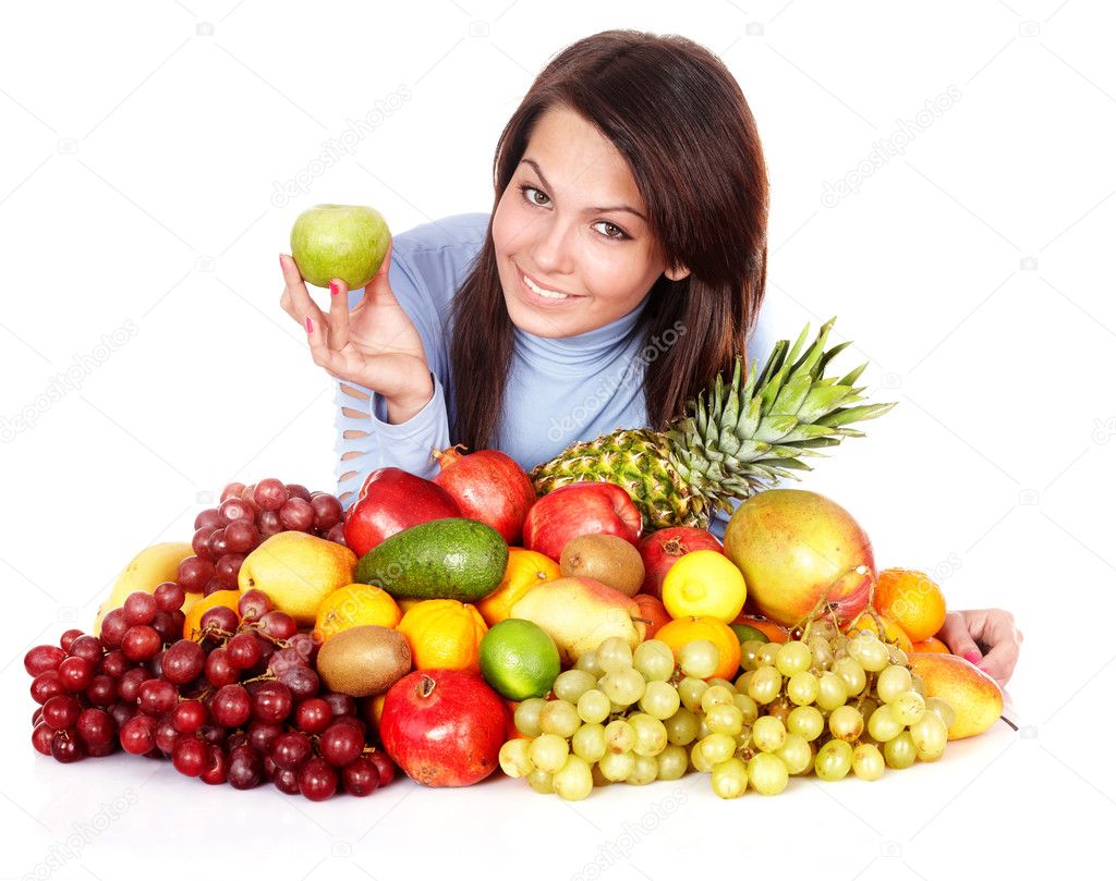 Girl with group of fruit and vegetables.