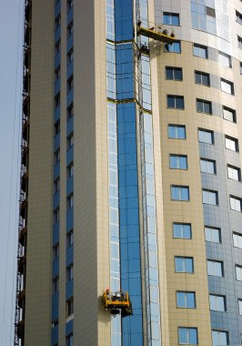 Builders on facade of building clipart