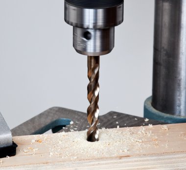 Close up of drill bit above wood clipart