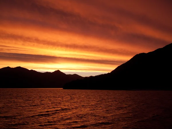 Sunset over water near Queenstown — Stock Photo, Image