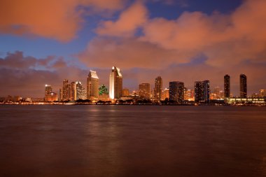 Orange clouds reflect light from San Diego Skyline clipart