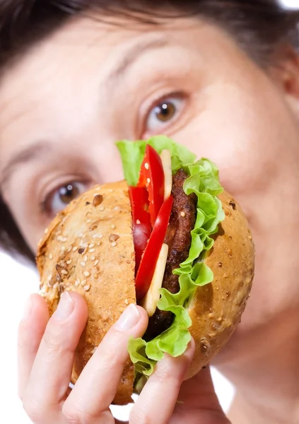 Stock image Woman eating hamburger