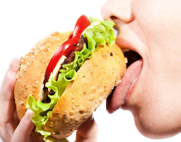 Žena jíst hamburger Stock Fotografie